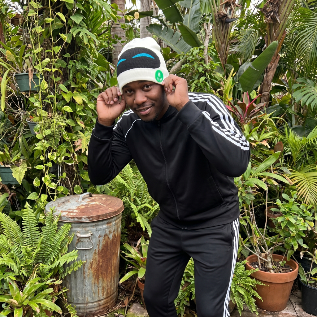 Person wearing a black tracksuit with white stripes in a garden setting