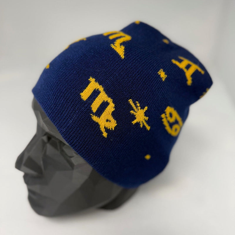 Blue beanie with yellow symbols on a mannequin head against a white background