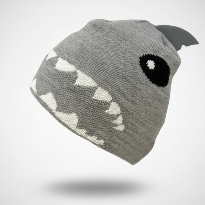 Gray beanie shaped like a shark with a black eye and white teeth on a light gray background