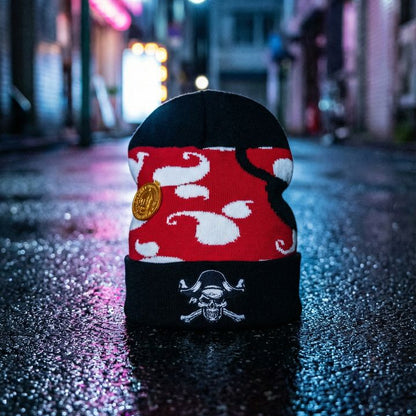 Red and black shoe with white designs on a wet street at night.
