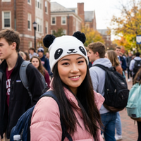 Woman wearing a panda hat among a crowd of people on a college campus