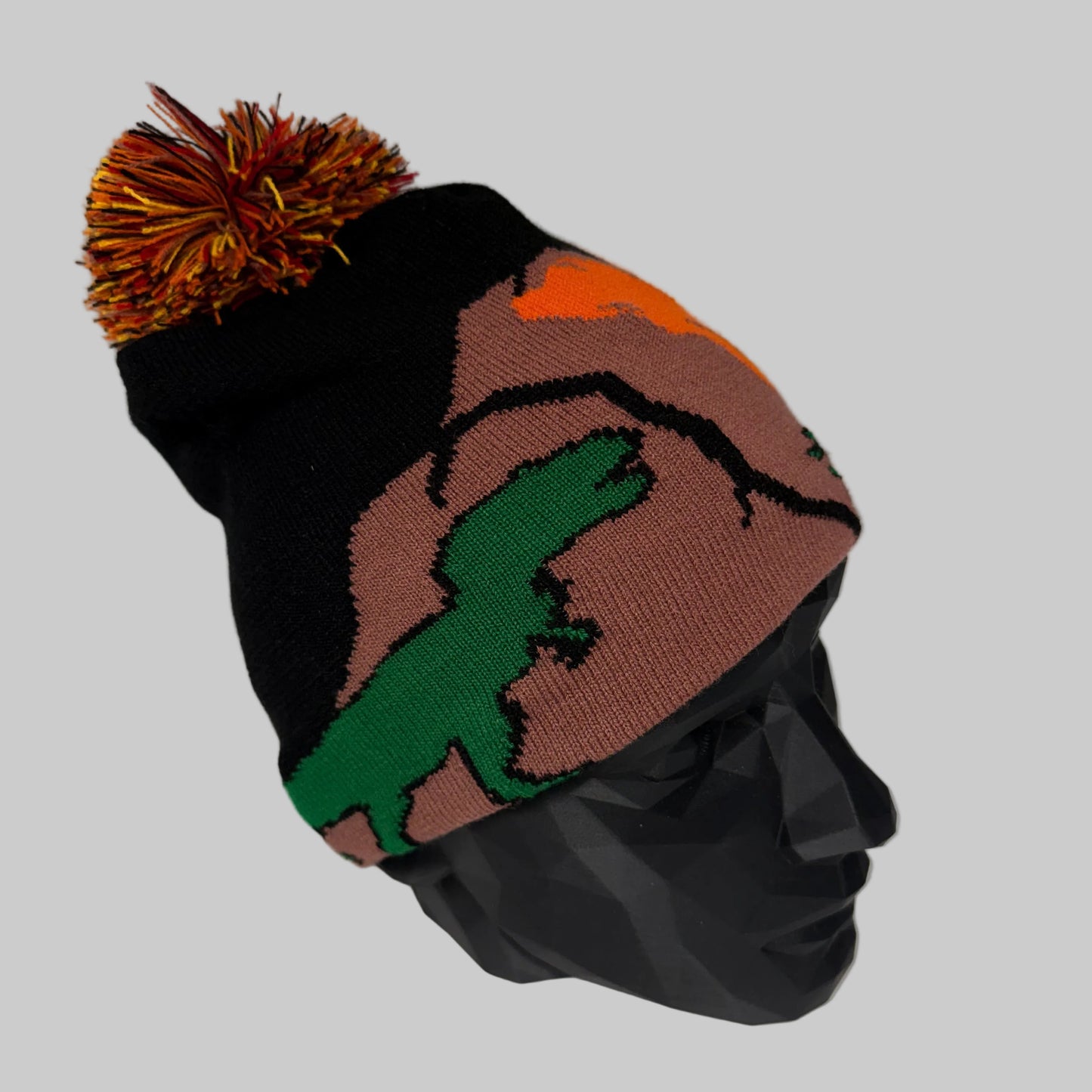 Colorful knit beanie with a pom-pom on a white background