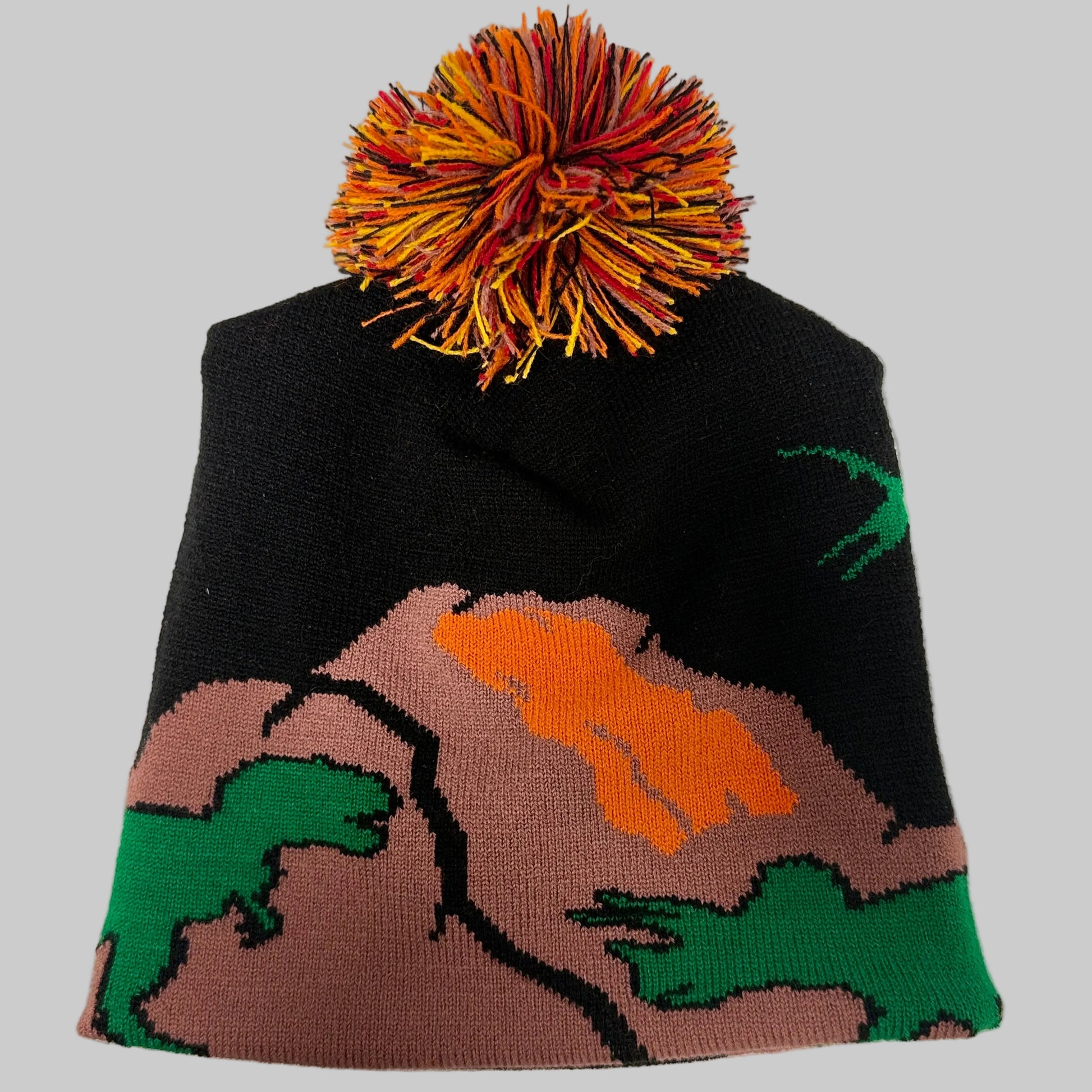 Knitted beanie with colorful pom-pom on a white background