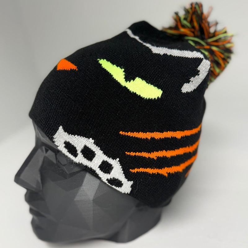 Black knit hat with colorful pom-pom on a mannequin head against a white background