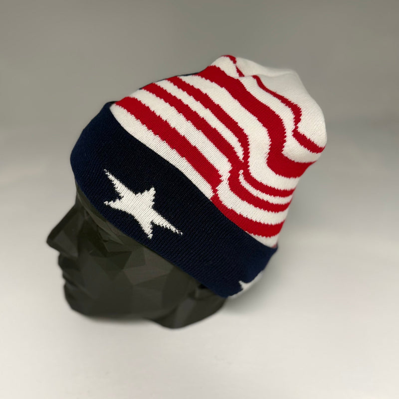 Knitted beanie with American flag pattern on a mannequin head against a gray background