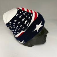 Knitted beanie with American flag pattern on a gray background