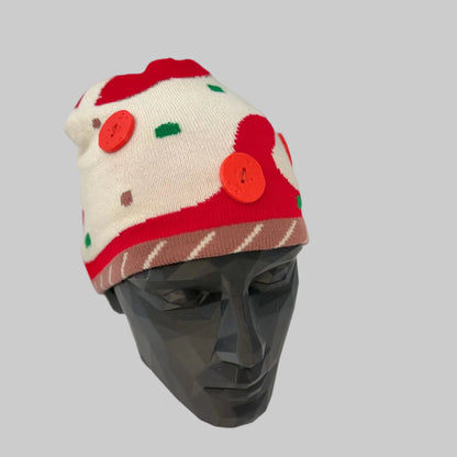 Knitted hat with red and white pattern on a mannequin head against a white background