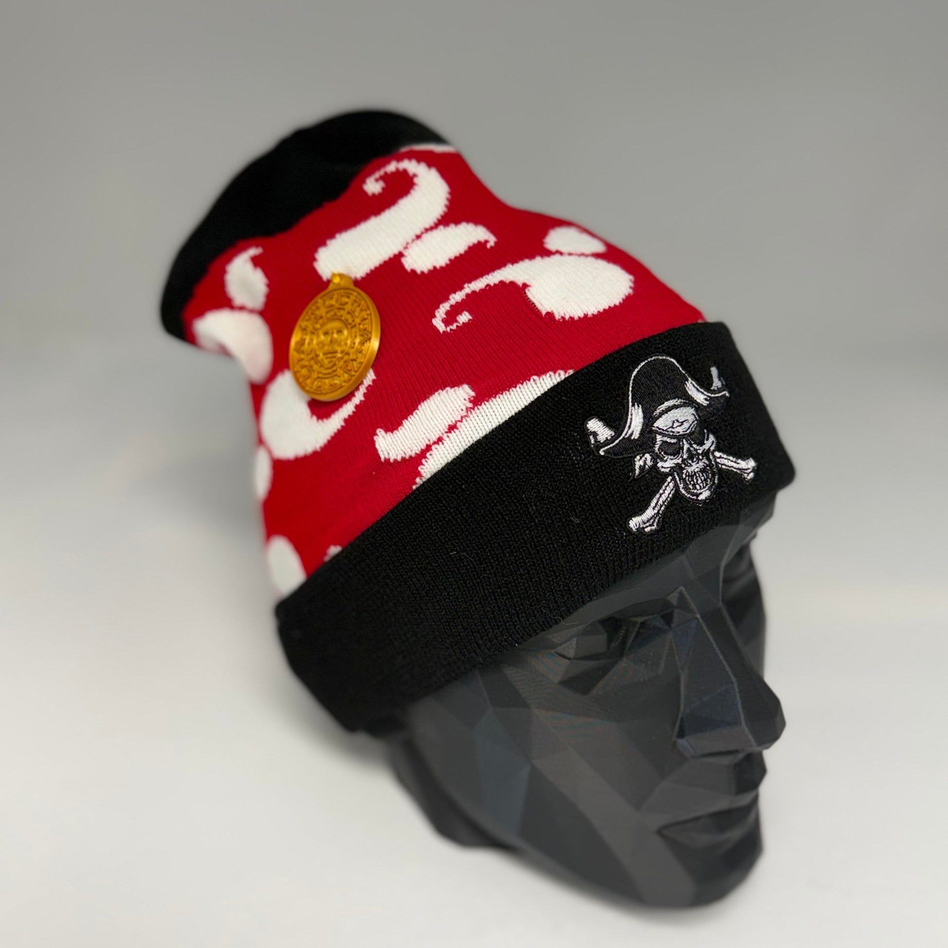 Red and white patterned headband with black band and skull design on a mannequin head.