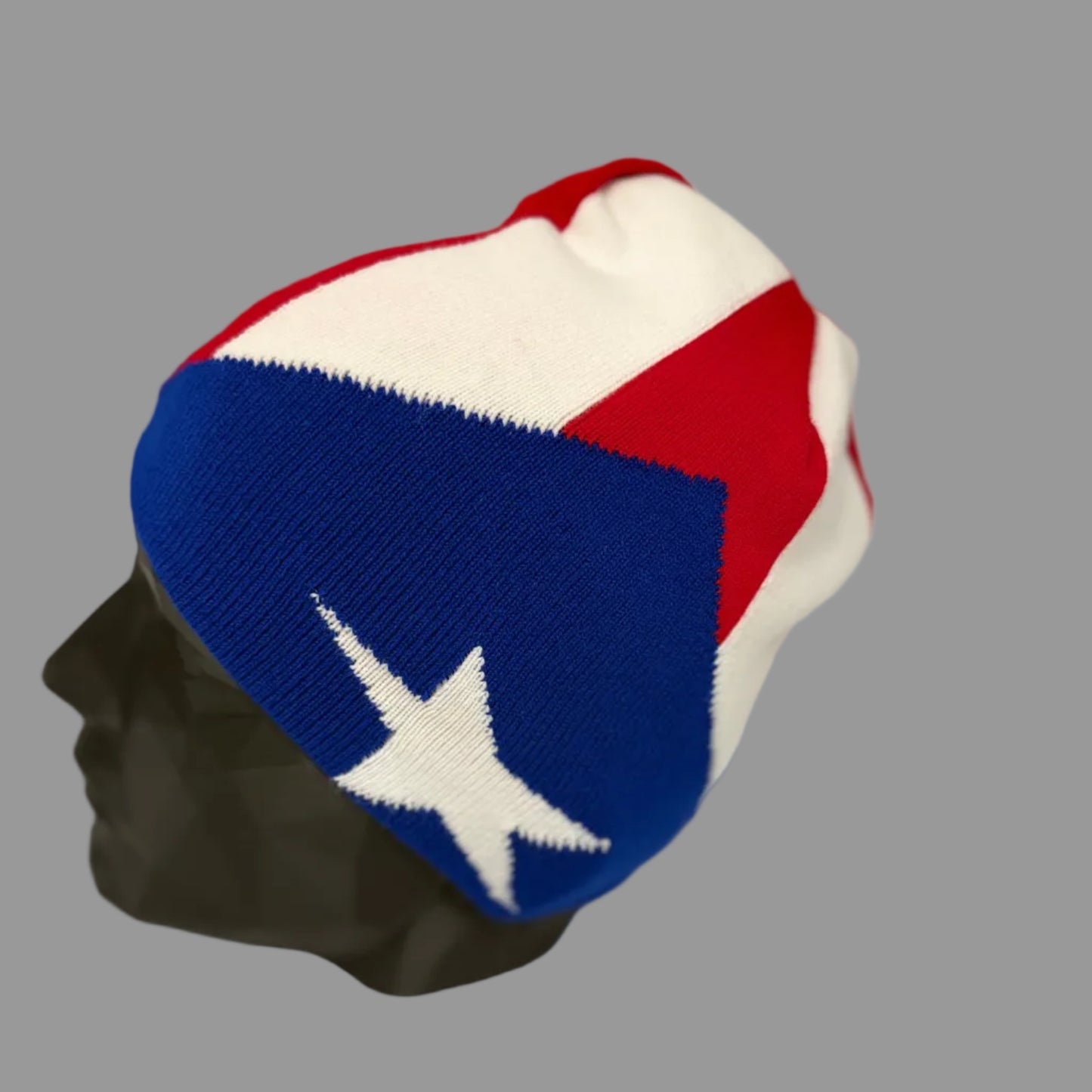 Colorful knit beanie with a star design on a mannequin head against a neutral background