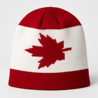 Red and white knit beanie with a maple leaf design on a white background