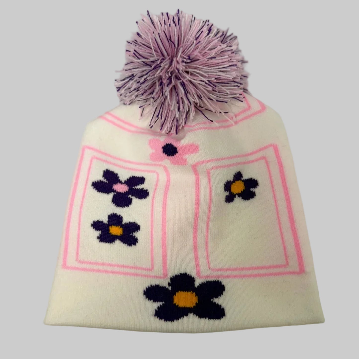 White knit beanie with purple flowers and a pink border on a white background
