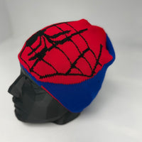 Mannequin head wearing a Spider-Man themed beanie with red and blue colors on a white background