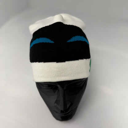 Knitted beanie with black, white, and blue pattern on a mannequin head against a gray background