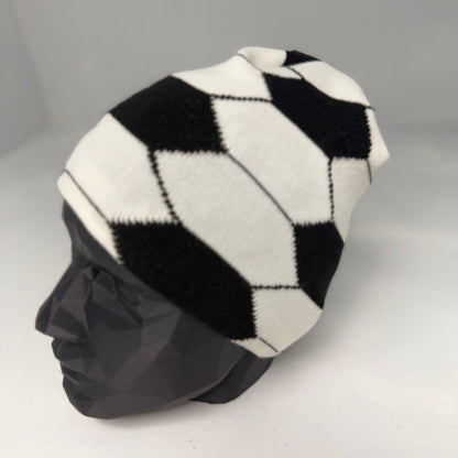 Black and white checkered beanie on a mannequin head against a gray background