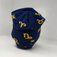 Blue beanie with yellow astrological symbol pattern on a white background