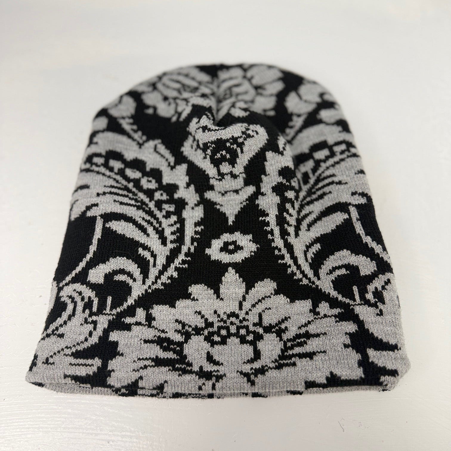 Black and white patterned beanie on a white background