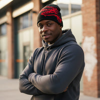 Black and red beanie on a black mannequin head against a white background