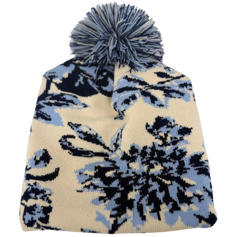 Floral patterned beanie with pom-pom on a white background