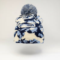 Blue and white patterned beanie with pom-pom on a mannequin head against a white background