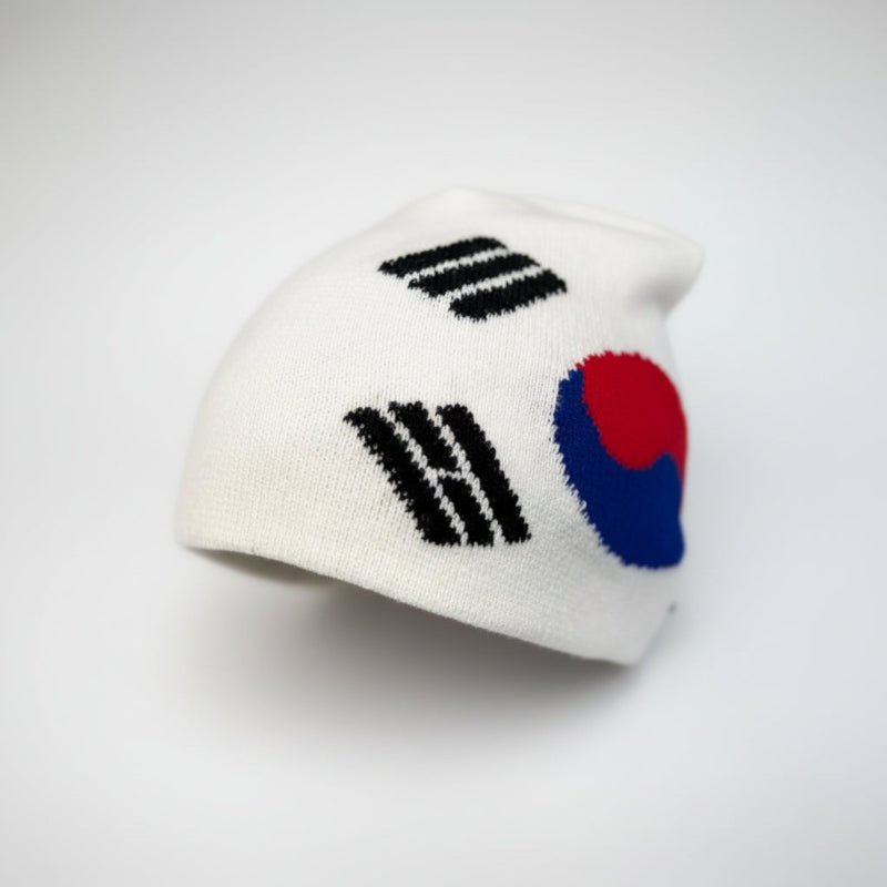White knit beanie with South Korean flag design on a gray background