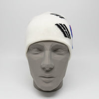 White beanie with black and blue designs on a black mannequin head against a gray background