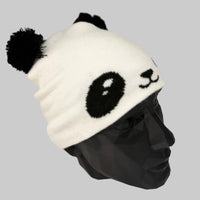 White beanie with panda face design on a gray background