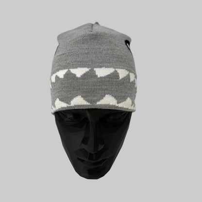 Gray and white patterned beanie on a mannequin head against a white background