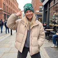 Girl wearing snowboard beanie in city street 