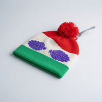 Colorful beanie with purple cloud designs on a white background