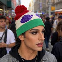 Person wearing a colorful beanie in a busy urban setting