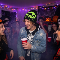 guy at party wearing slime beanie 