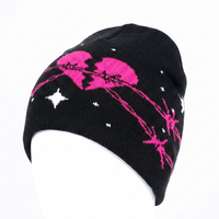 Black beanie with pink and white designs on a white background