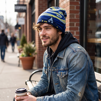 Starry Night beanie on a man in denim holding coffee