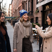 Woman in tan scarf wearing starry night beanie 