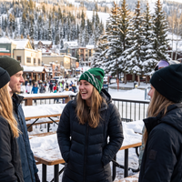 girl ln black puff coat wearing green snowboarder beanie 