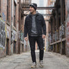 man wearing shooting star beanie in alley