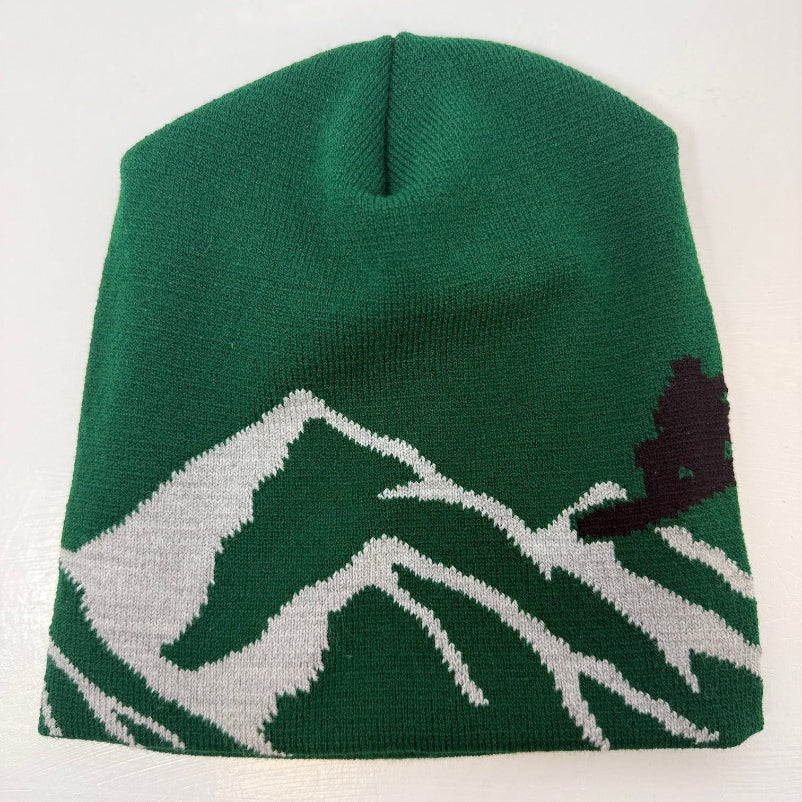 Green beanie with mountain and tree design on a white background
