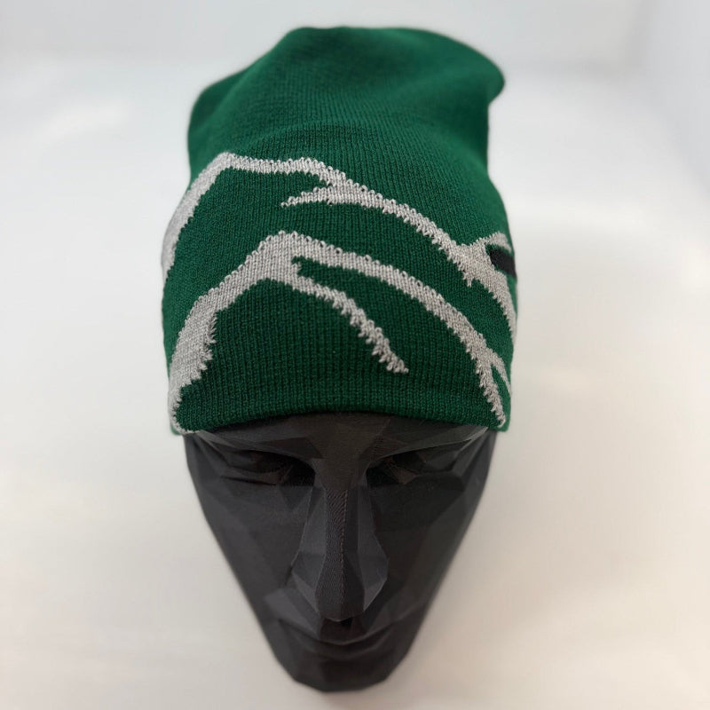 Green beanie with white pattern on a mannequin head against a white background