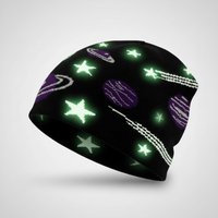Glowing space-themed beanie with stars, planets, and galaxies on a gray background