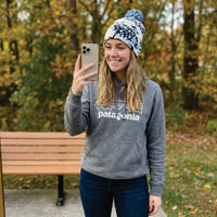Person wearing a Patagonia hoodie taking a selfie outdoors.